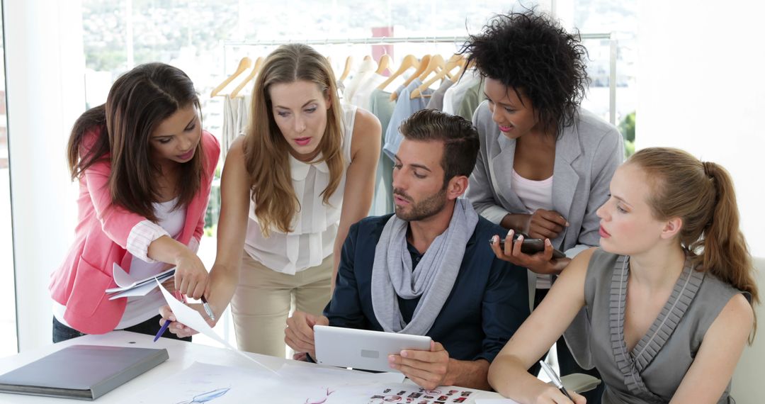 Fashion Design Team Collaborating in Studio
