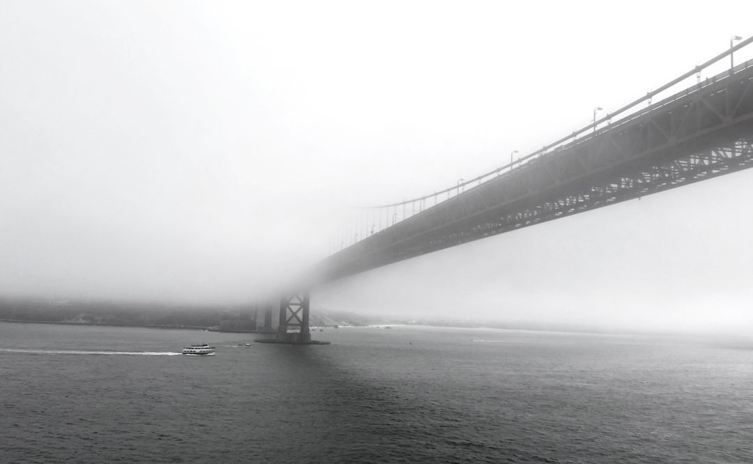Boat Sailing Under Foggy Bridge in Black and White - Free Images, Stock Photos and Pictures on Pikwizard.com