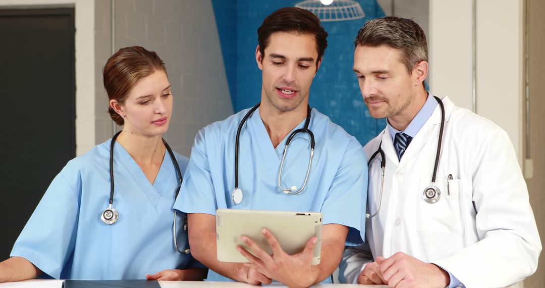 Healthcare Professionals Discussing Patient Records with a Tablet - Free Images, Stock Photos and Pictures on Pikwizard.com