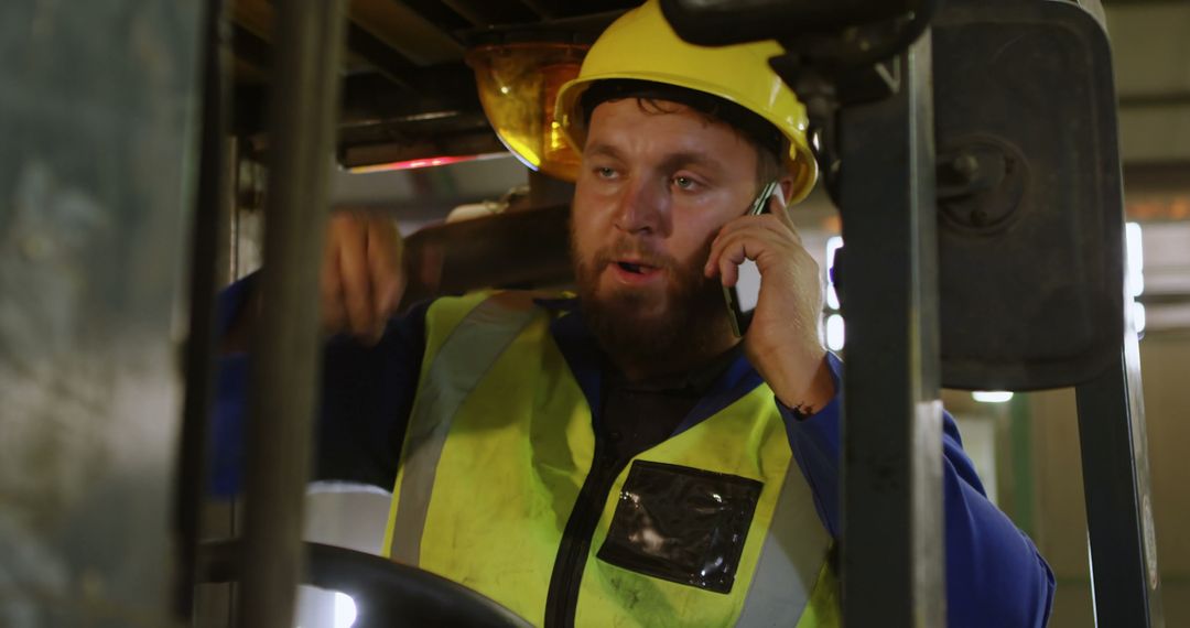 Construction Worker Communicating via Phone on Industrial Machinery - Free Images, Stock Photos and Pictures on Pikwizard.com