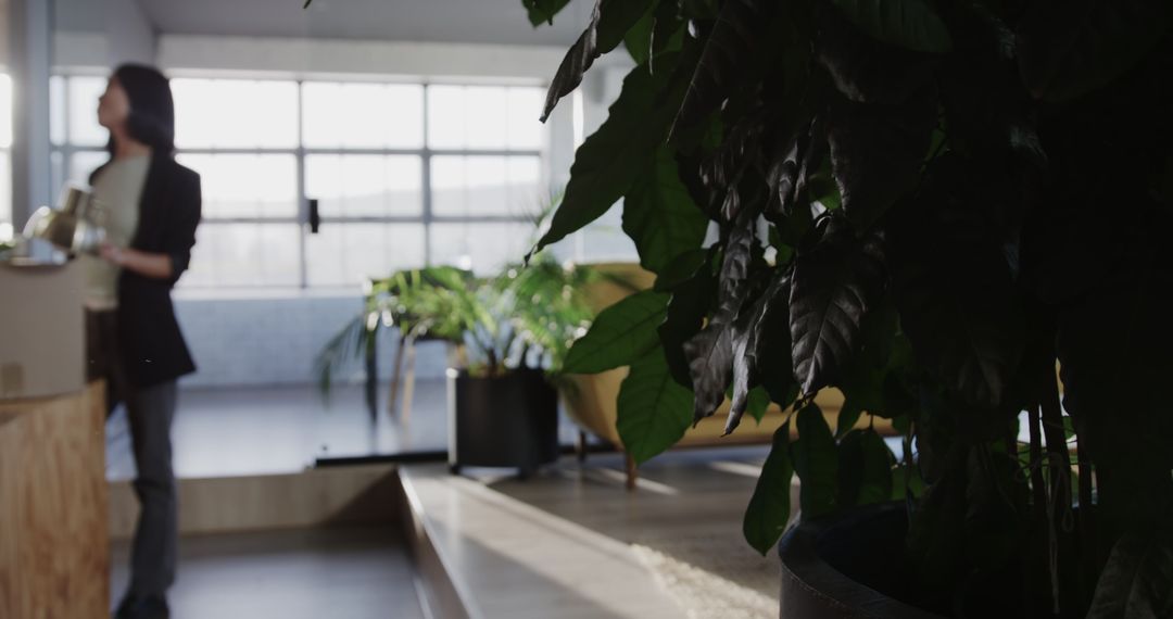 Colleagues Discussing Project in Open Office with Greenery