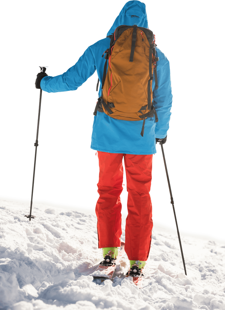 Skier with Orange Backpack on Snowy Terrain