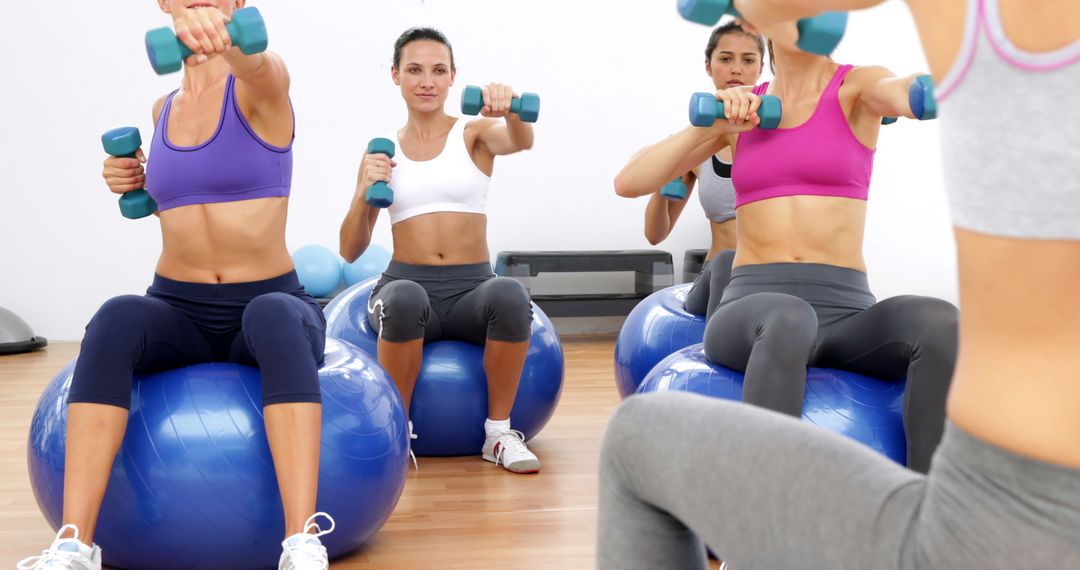 Women Exercising with Dumbbells on Stability Balls in Fitness Class - Free Images, Stock Photos and Pictures on Pikwizard.com