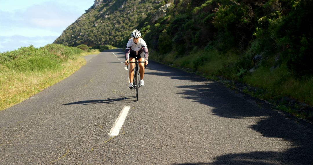 Cyclist Enjoying Ride on Scenic Mountain Road - Free Images, Stock Photos and Pictures on Pikwizard.com