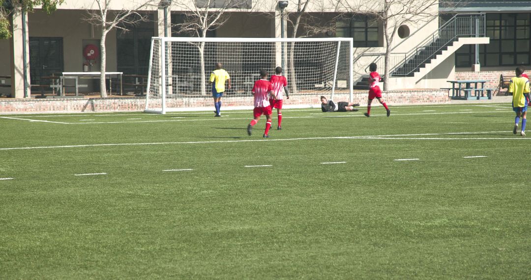 Youth Soccer Players Competing on Field Focuses on Team Strategy
