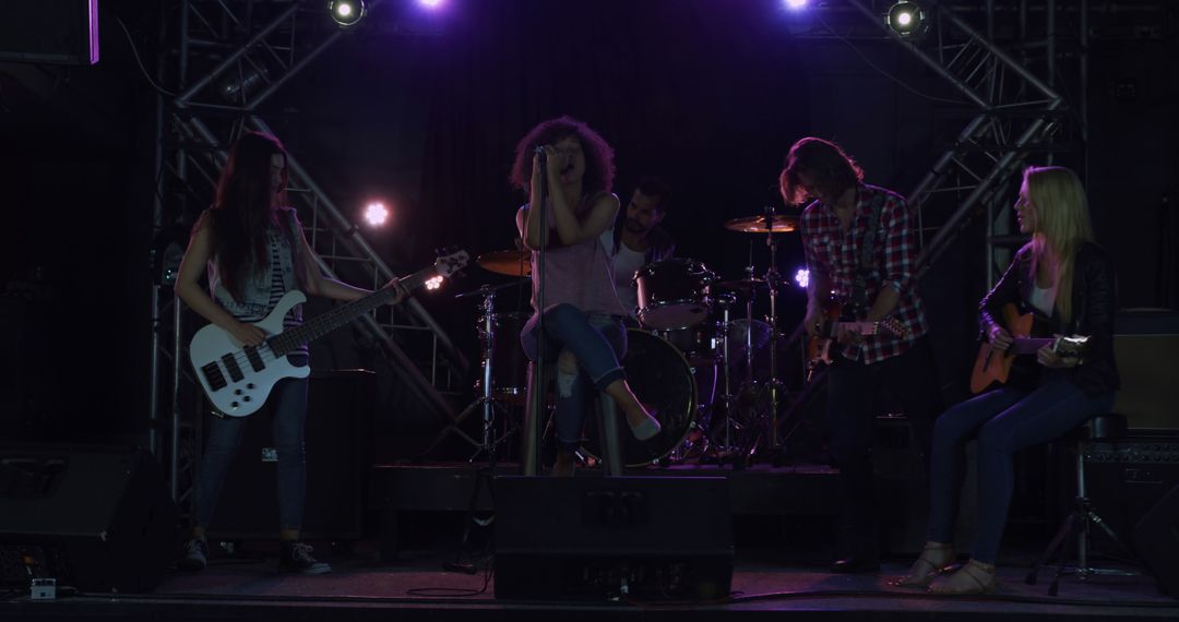 Diverse Band Rehearsing Together Under Stage Lights