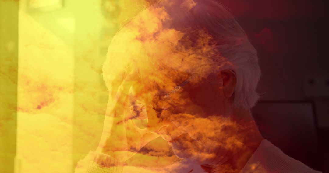 Pensive Elder With Dreamy Cloud Overlay Expressing Contemplation