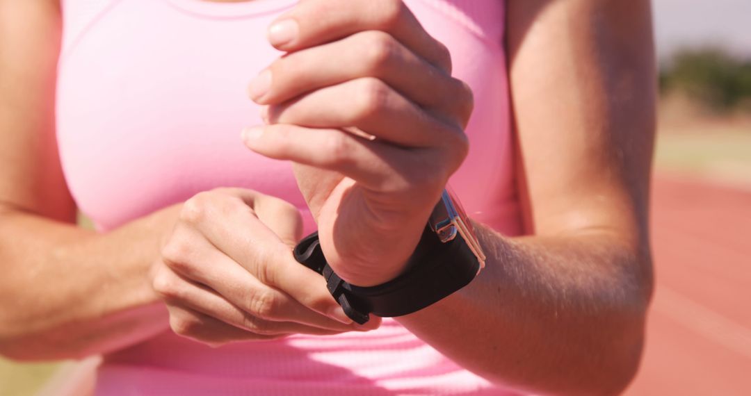 Woman Adjusting Smartwatch While Exercising Outdoors - Free Images, Stock Photos and Pictures on Pikwizard.com