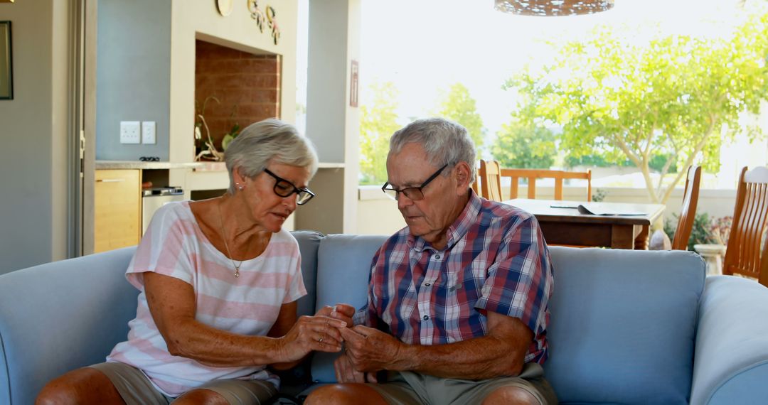 Senior Couple Engaged in Conversation on Couch at Home