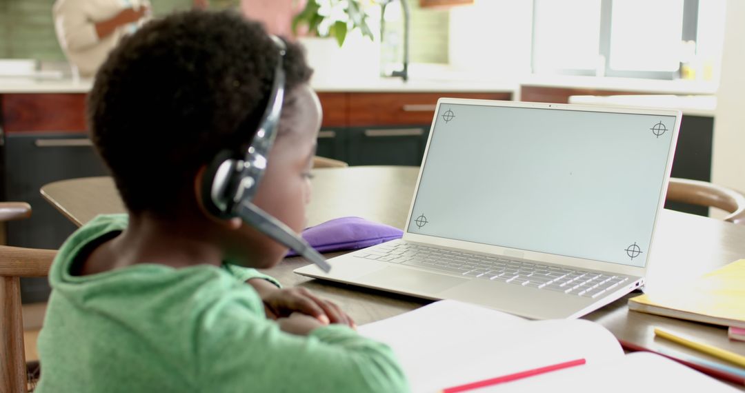 Child Engaging in Online Learning with Headset and Laptop in Bright Room - Free Images, Stock Photos and Pictures on Pikwizard.com