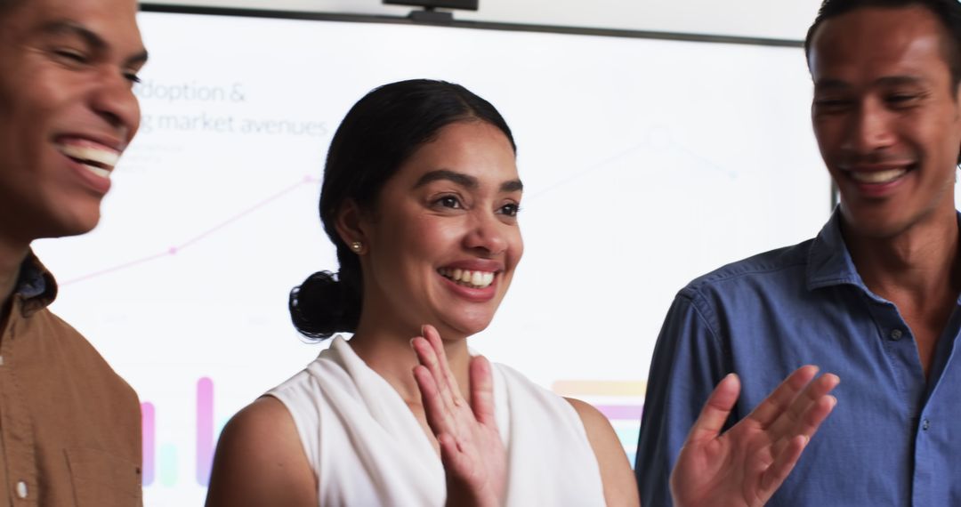 Joyful Multiracial Team Celebrating Success in Office Meeting