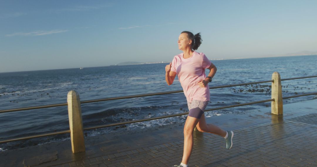 Woman Jogging on Seaside Promenade at Sunrise - Free Images, Stock Photos and Pictures on Pikwizard.com