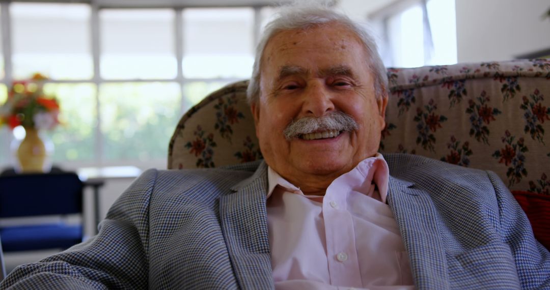 Senior Man Relaxing and Smiling in Comfortable Armchair