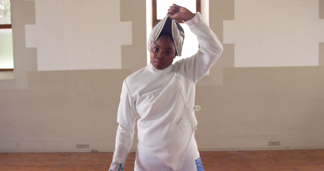 Female Fencer Removing Helmet, Indoor Training Session - Free Images, Stock Photos and Pictures on Pikwizard.com