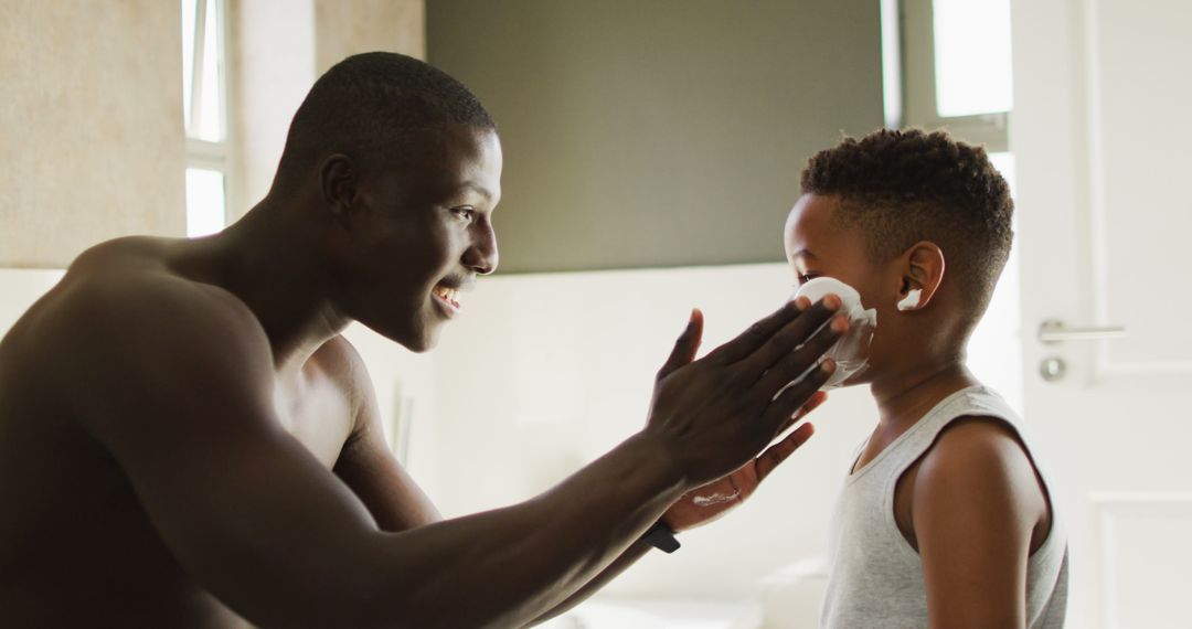 Father Applying Shaving Cream to Son in Bathroom - Free Images, Stock Photos and Pictures on Pikwizard.com