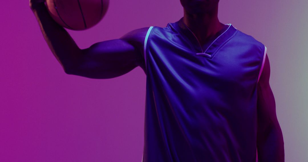 Athlete Holding Basketball in Neon Purple Light - Free Images, Stock Photos and Pictures on Pikwizard.com