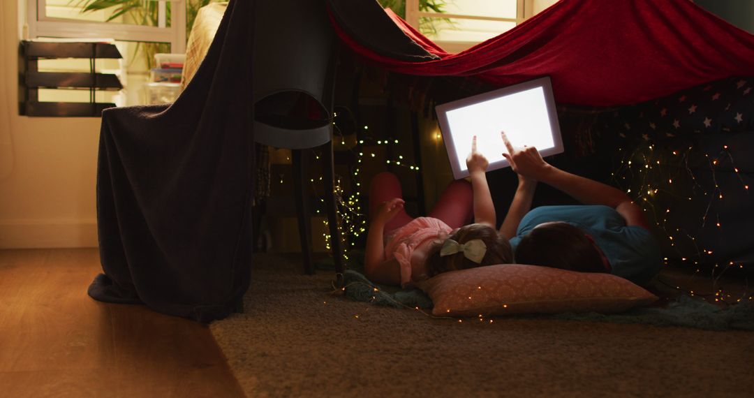 Children Using Tablet Under Blanket Fort at Home - Free Images, Stock Photos and Pictures on Pikwizard.com