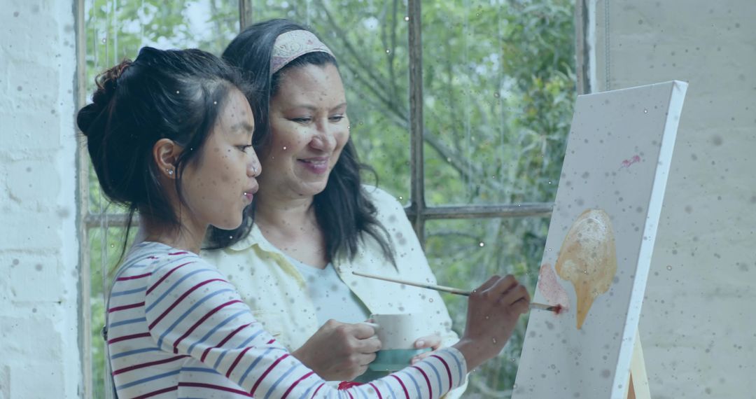 Mother and daughter painting together by window sharing creative mentorship and bonding