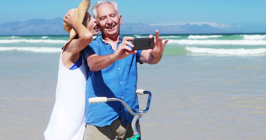 Happy Senior Couple Taking Selfie on Bicycle at Beach - Free Images, Stock Photos and Pictures on Pikwizard.com