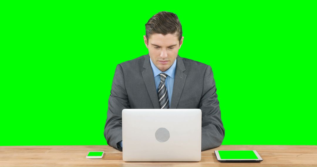 Businessman Working on Laptop with Green Screen Background - Free Images, Stock Photos and Pictures on Pikwizard.com