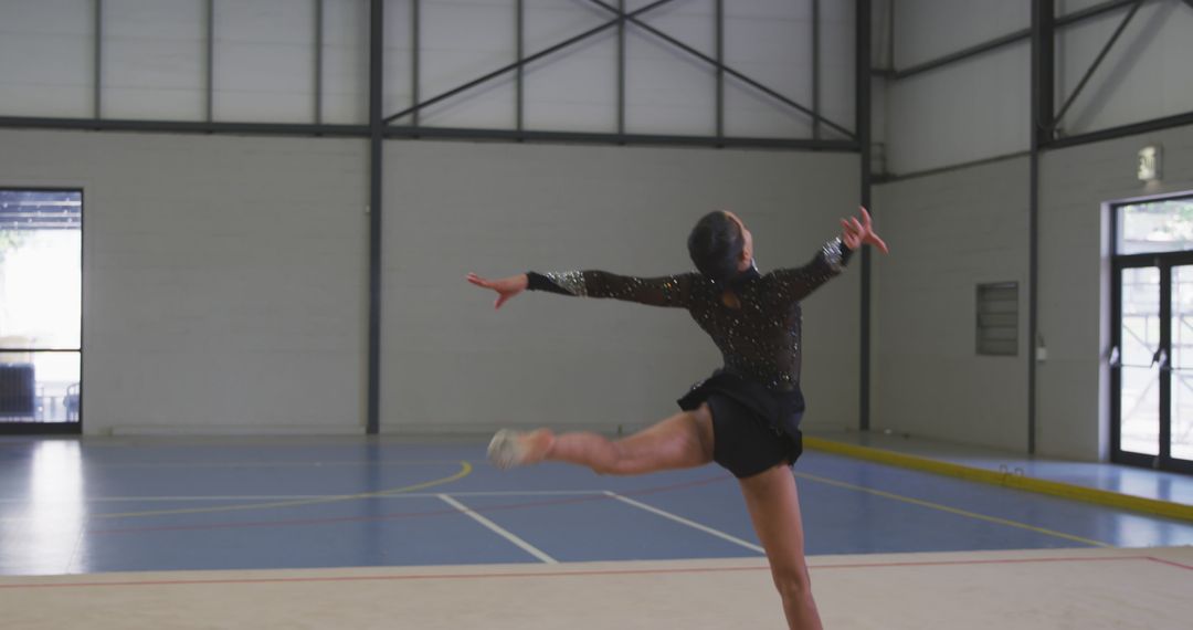 Graceful Gymnast Performing Routine in Indoor Gymnasium - Free Images, Stock Photos and Pictures on Pikwizard.com