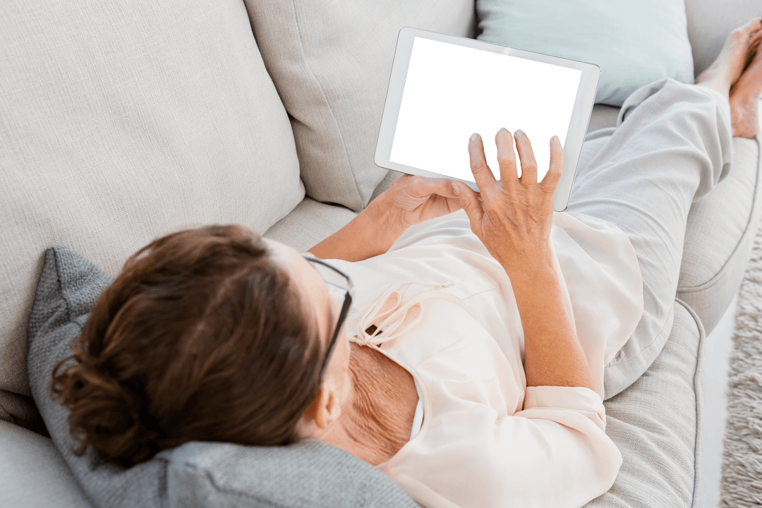 Transparent Smart Tablet User Relaxing at Home on Comfortable Sofa