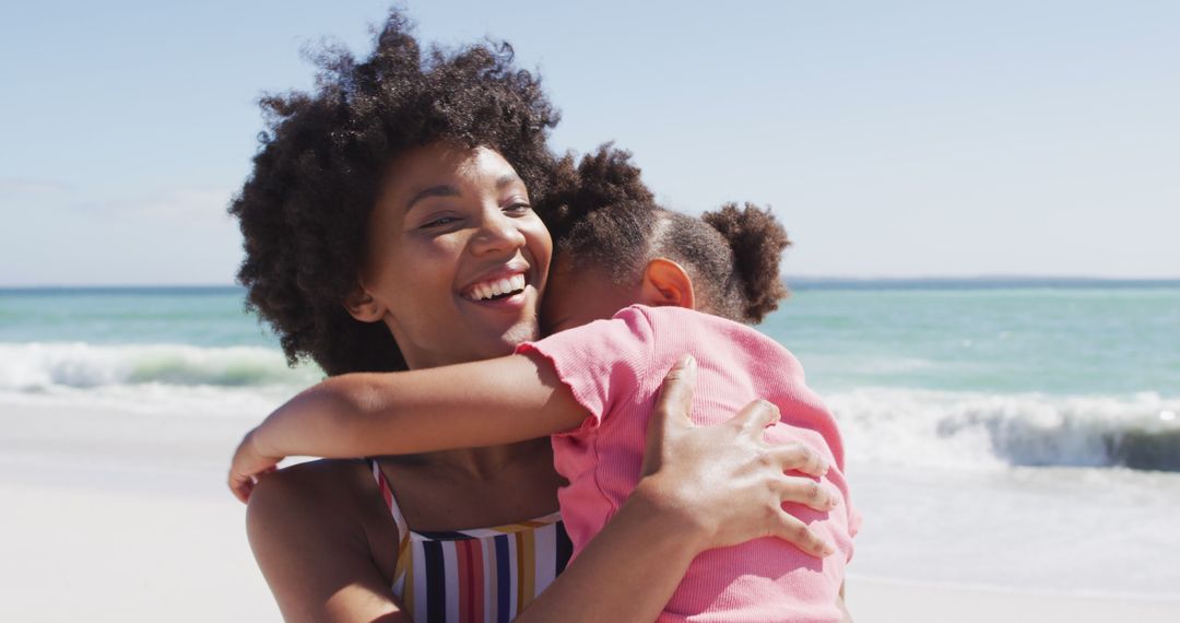 Joyful African American Mom Hugging Her Daughter on Beach - Free Images, Stock Photos and Pictures on Pikwizard.com