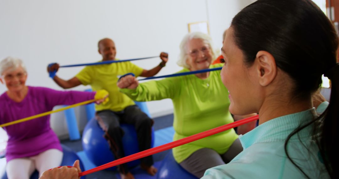 Senior Exercise Group Stretching with Trainer and Resistance Bands