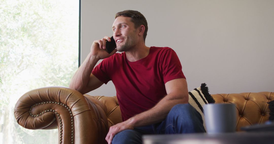 Caucasian man casually chatting on smartphone at home