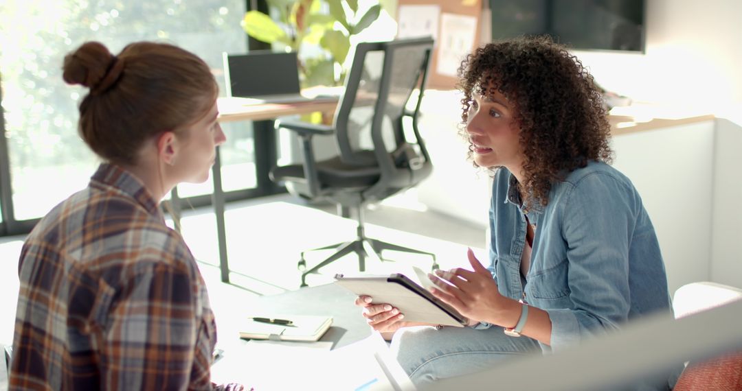 Female Colleagues Collaborating in Stylish Office Environment