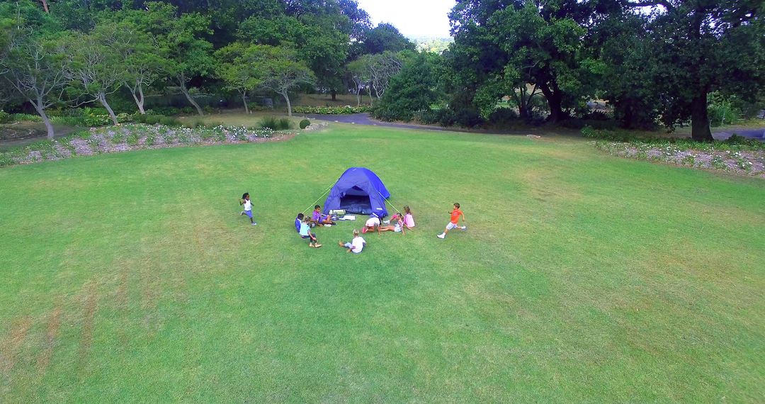 Children Playing Around Blue Tent in Open Field - Free Images, Stock Photos and Pictures on Pikwizard.com