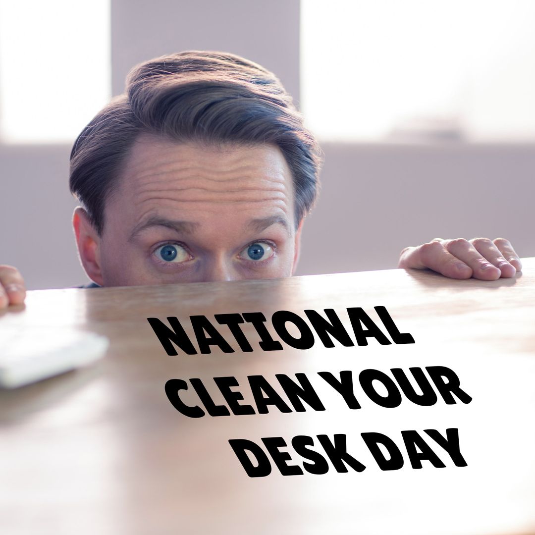 Man Peeking over Desk for National Clean Your Desk Day
