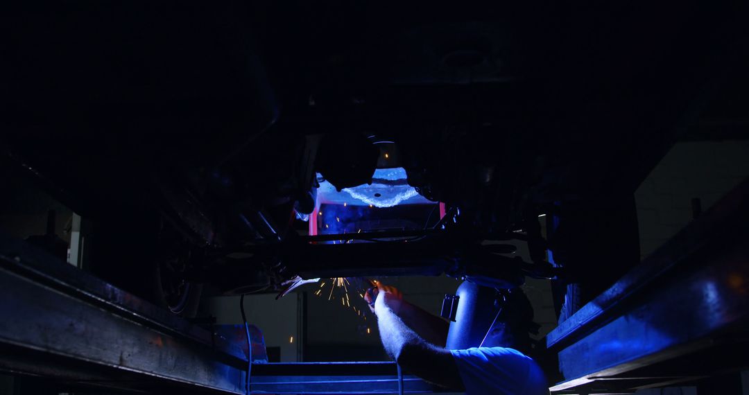 Welder Working on Vehicle Undercarriage at Night in Workshop - Free Images, Stock Photos and Pictures on Pikwizard.com