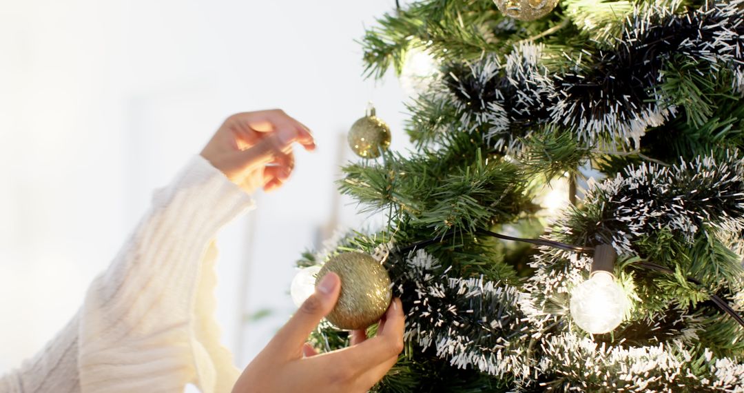 Decorating Christmas Tree with Gold Ornaments in Cozy Home