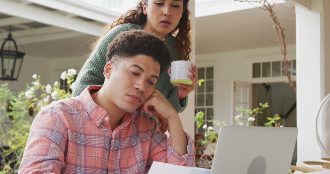 Image of biracial couple using laptop in the garden - Free Images, Stock Photos and Pictures on Pikwizard.com