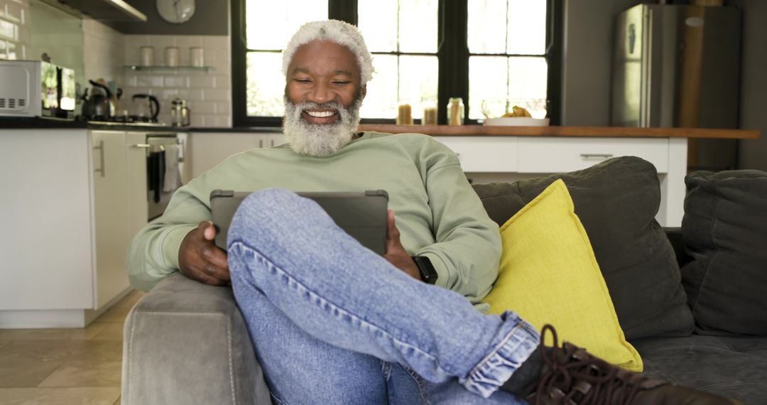 Senior Man Relaxing at Home with Tablet in Cozy Living Space