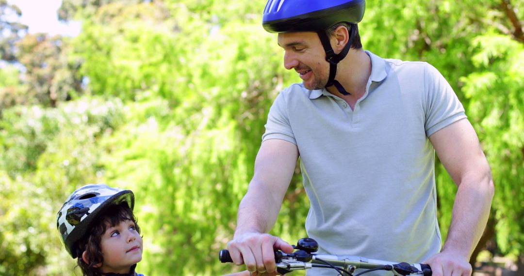 Father and Son Enjoying a Bike Ride in the Park - Free Images, Stock Photos and Pictures on Pikwizard.com