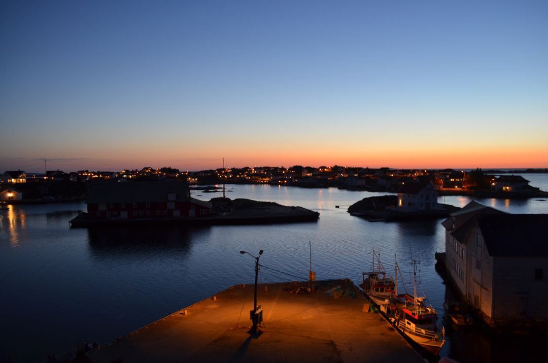 Sunset Over Coastal Village with Calm Waters and Boat Dock - Free Images, Stock Photos and Pictures on Pikwizard.com