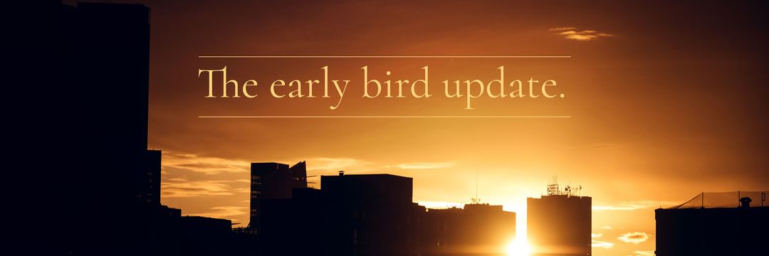 Sunrise over city silhouettes with motivational quote