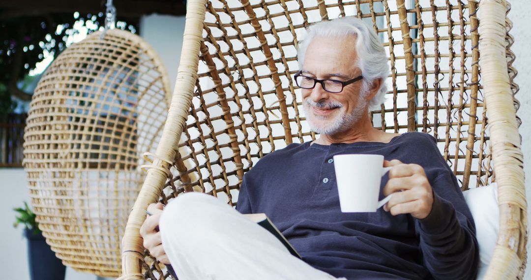 Senior Man Relaxing in Garden with Coffee and Book