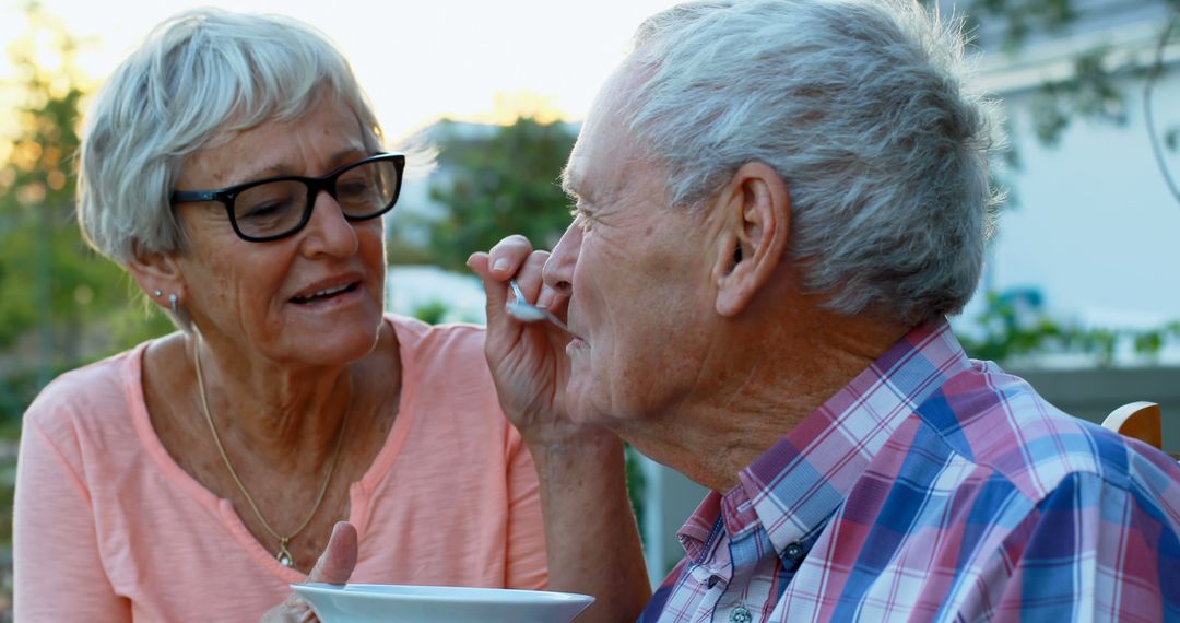 Elderly Woman Feeding Senior Man Outdoors in Nature - Free Images, Stock Photos and Pictures on Pikwizard.com