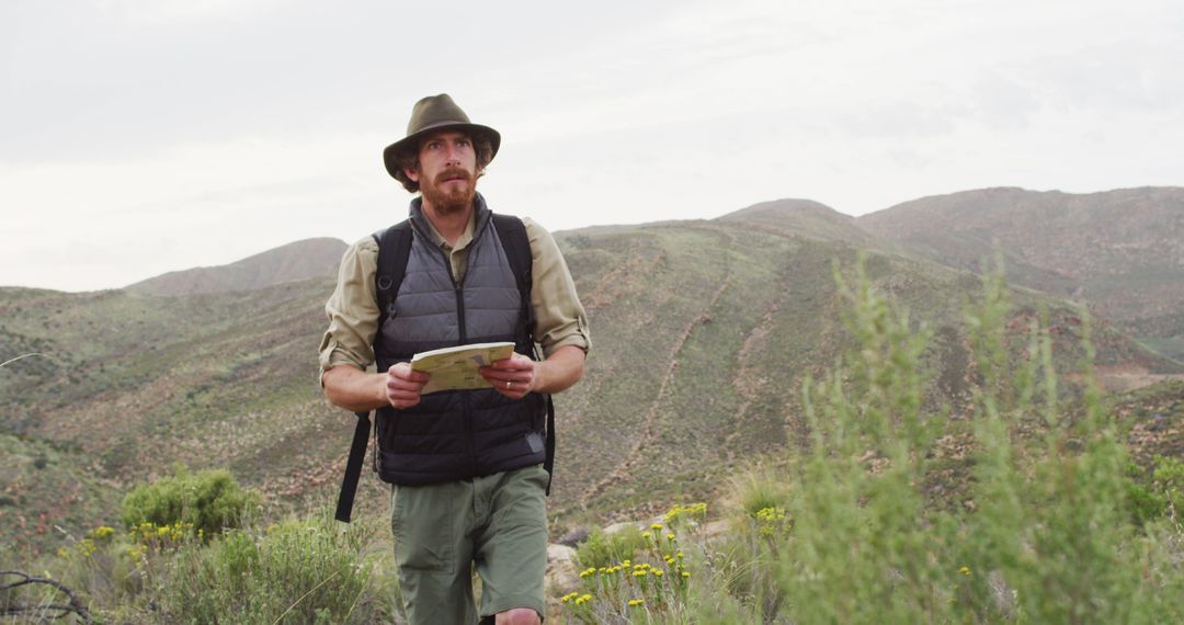 Male Explorer Navigating in Mountain Wilderness - Free Images, Stock Photos and Pictures on Pikwizard.com