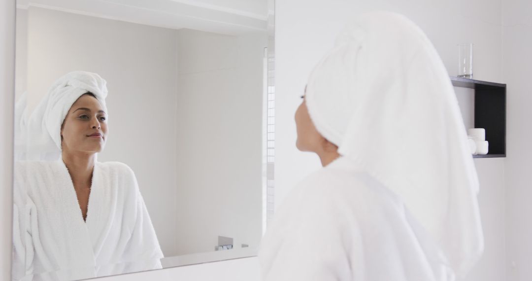 Woman in Bathrobe with Towel Turban Looking into Bathroom Mirror - Free Images, Stock Photos and Pictures on Pikwizard.com