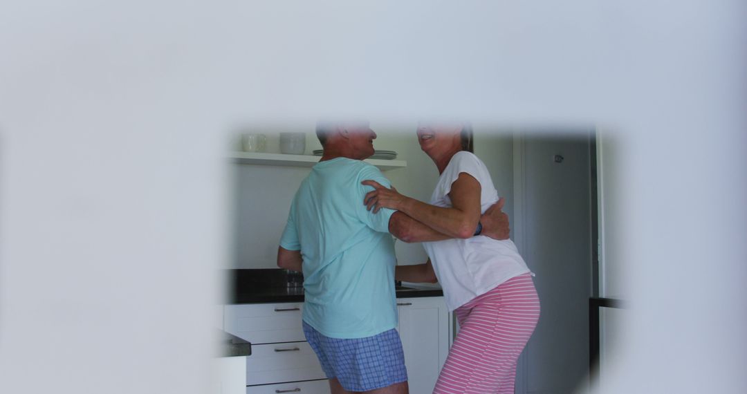 Caucasian senior couple dancing together at home - Free Images, Stock Photos and Pictures on Pikwizard.com