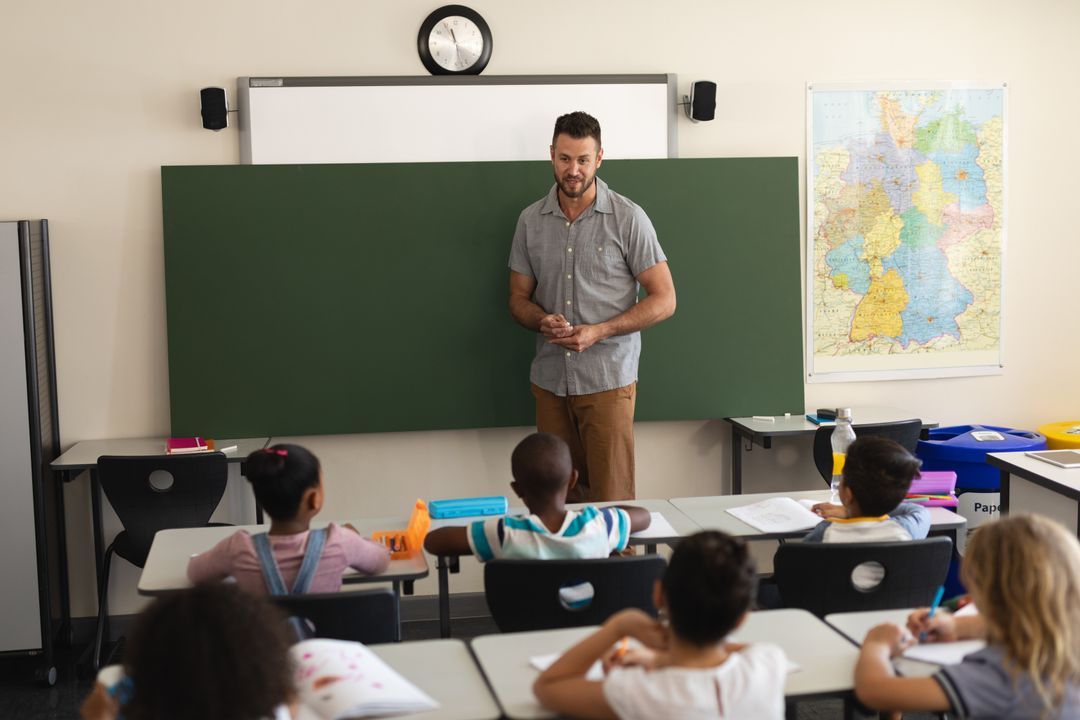 Male Teacher Instructing Diverse Elementary School Students - Free Images, Stock Photos and Pictures on Pikwizard.com