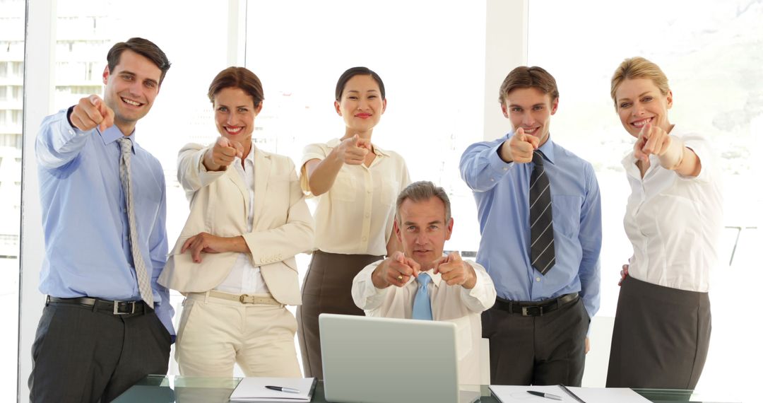 Confident Business Team Pointing Forward in Office Setting