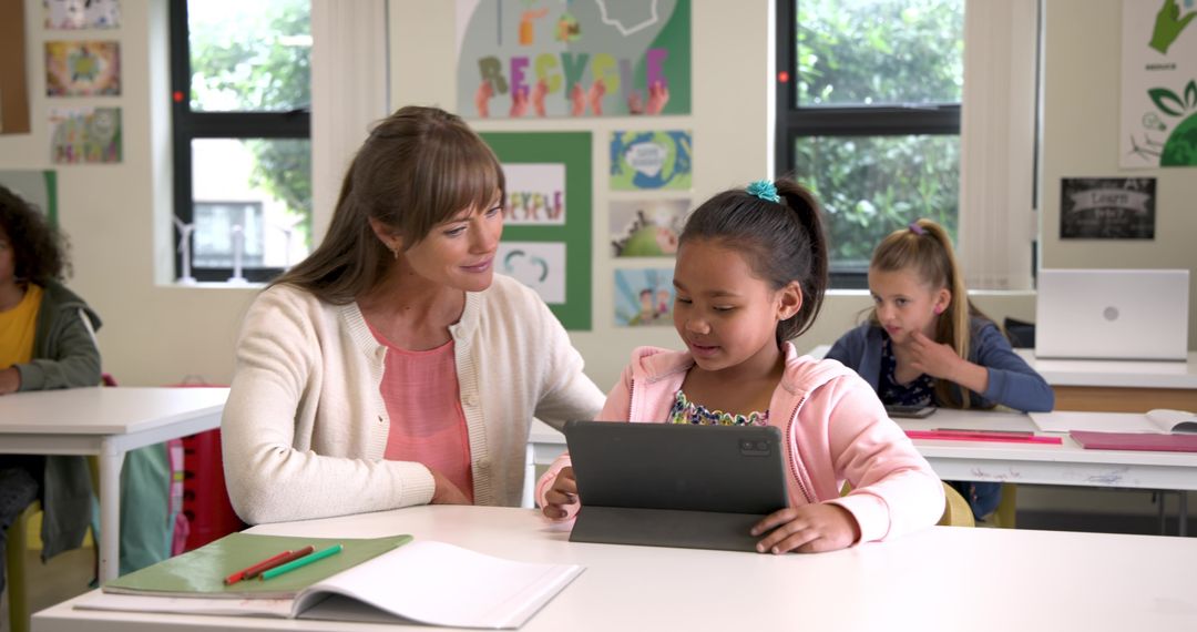 Teacher Guiding Student Through Tablet Learning in Classroom