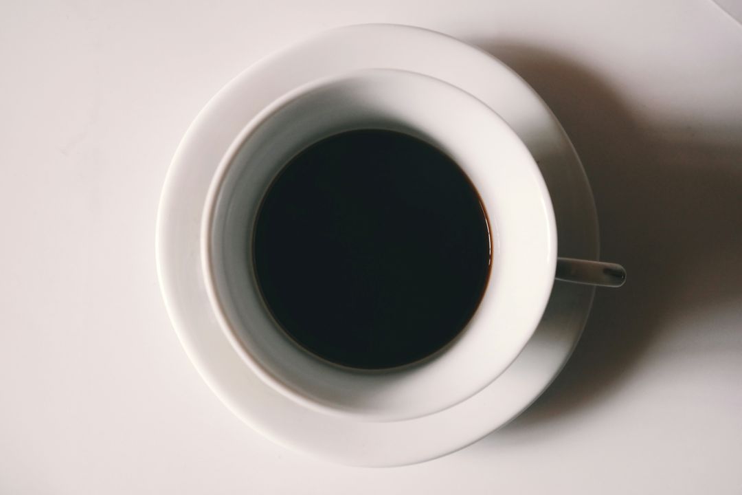 Top View of Cup of Black Coffee on White Background - Free Images, Stock Photos and Pictures on Pikwizard.com