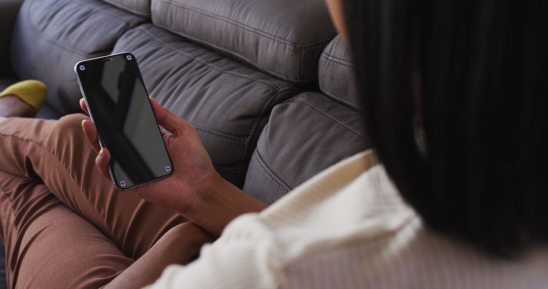 Person Relaxing on Couch Holding Smartphone with Blank Screen - Free Images, Stock Photos and Pictures on Pikwizard.com