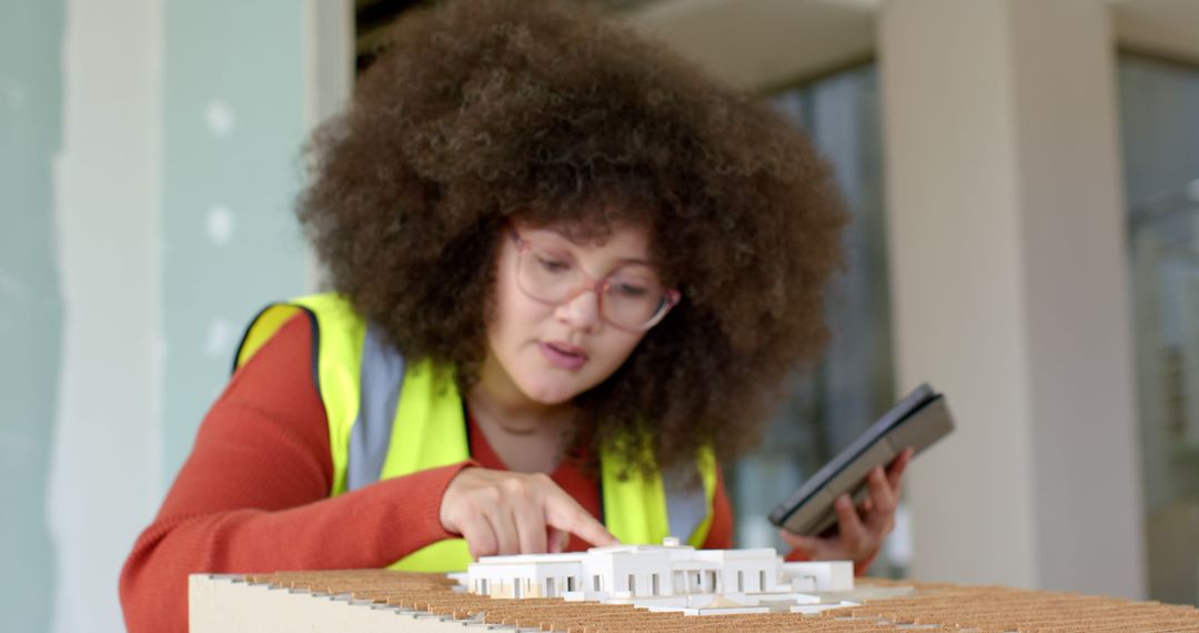 Female Architect Examining Architectural Model in Office - Free Images, Stock Photos and Pictures on Pikwizard.com